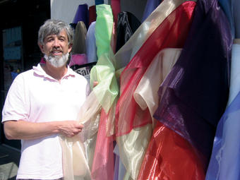 Party planner Roy Braeger ’86 with some of the colorful fabrics he uses in designing an event setting. PHOTO: JON COURIE
